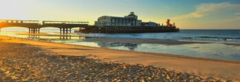 Jetée de Bournemouth au coucher du soleil avec fond d'océan calme.