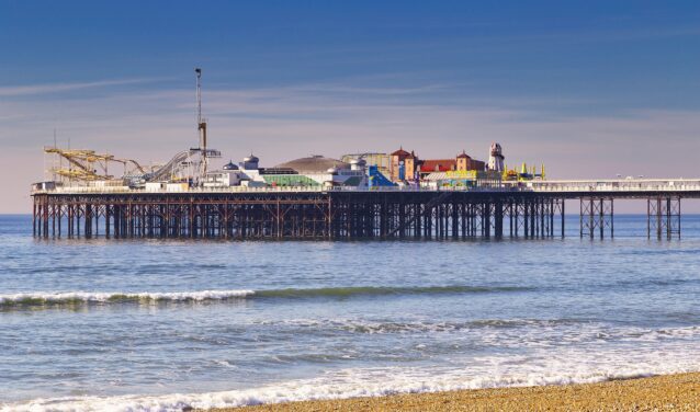 Brighton : jetée, mer calme, ciel dégagé, plage de galets.